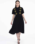 Fanm Mon Mehtap Dress on model in black velvet featuring gold rose embroidery, short kimono-style sleeves and a flared midi skirt