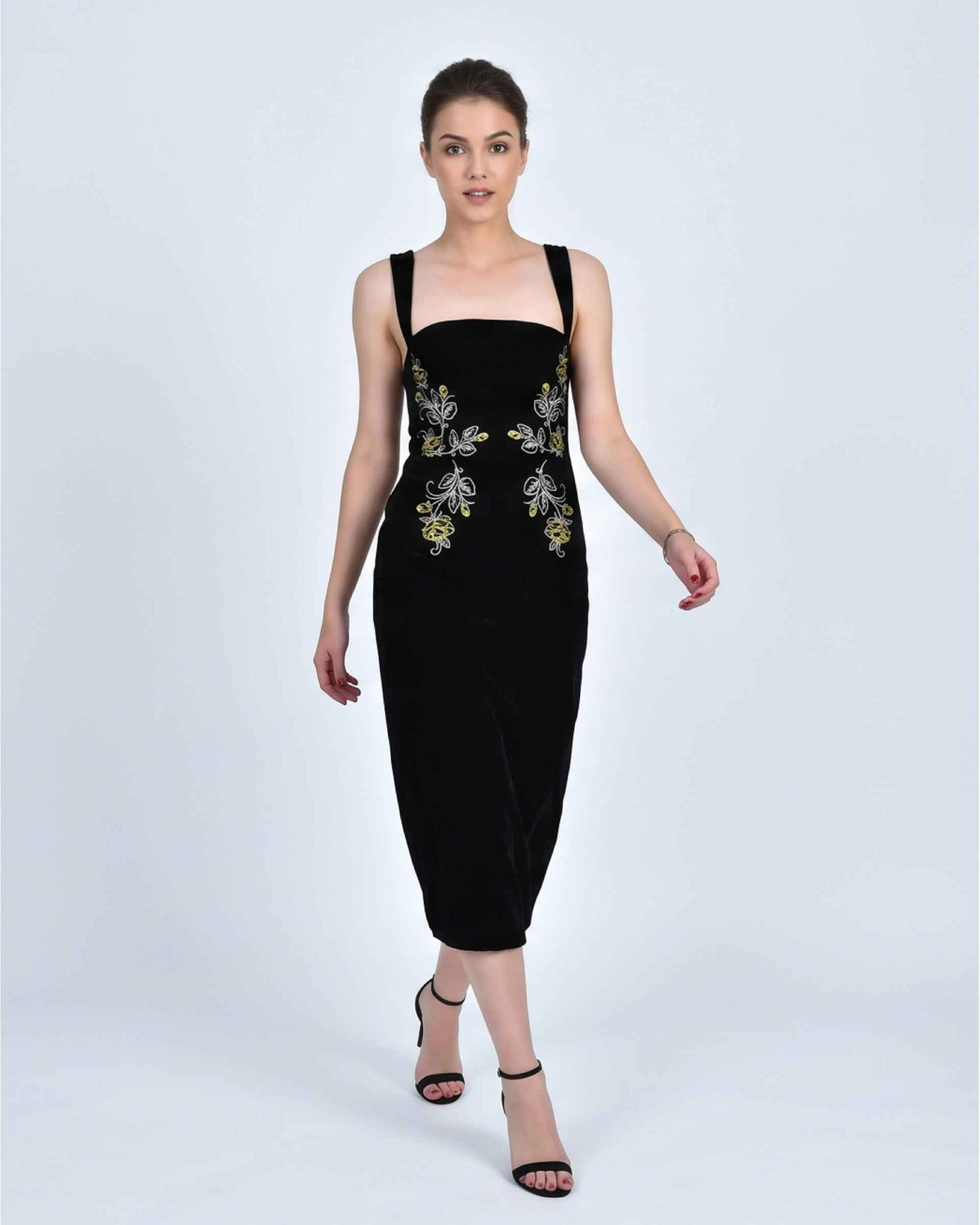 Fanm Mon Meltem Dress on model in black velvet featuring gold and silver rose embroidery, a square neckline and fitted midi silhouette