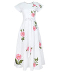 Fanm Mon Pervin Dress in white featuring a round neckline, short sleeves, self-tie waist belt, and pink rose embroidery with green foliage across the flowing A-line midi skirt.