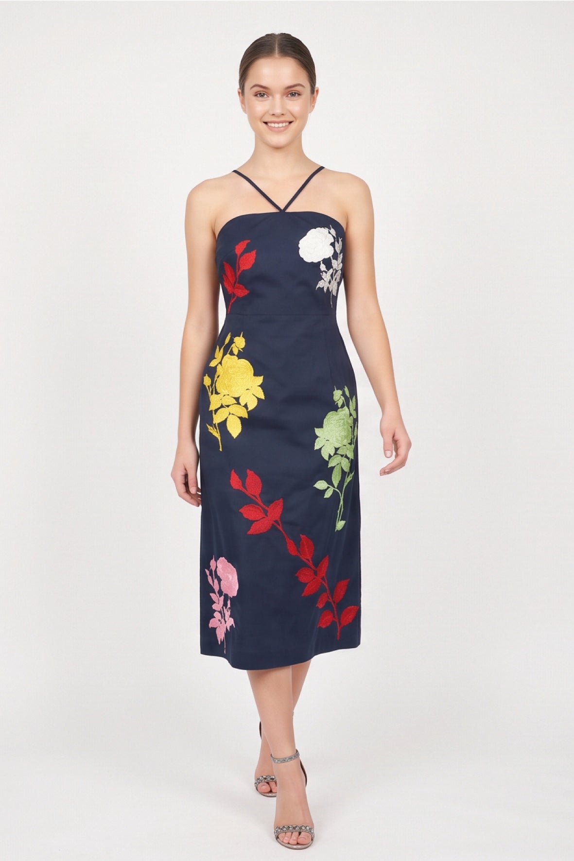 Model wearing Fanm Mon Pout Dress with colorful botanical embroidery and a fitted midi silhouette