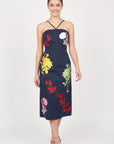Model wearing Fanm Mon Pout Dress with colorful botanical embroidery and a fitted midi silhouette