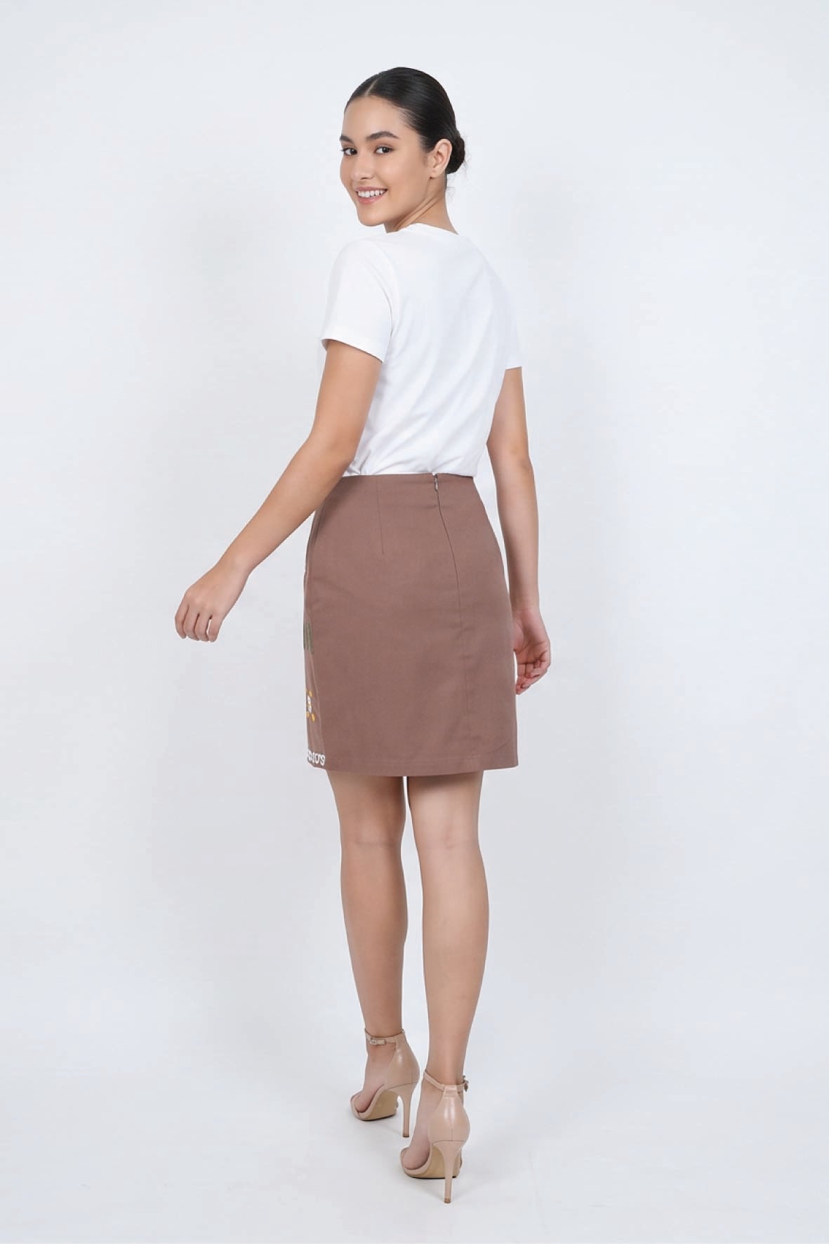 Fanm Mon Roya Skirt back view on model featuring a high waist, clean mini silhouette and concealed back zipper