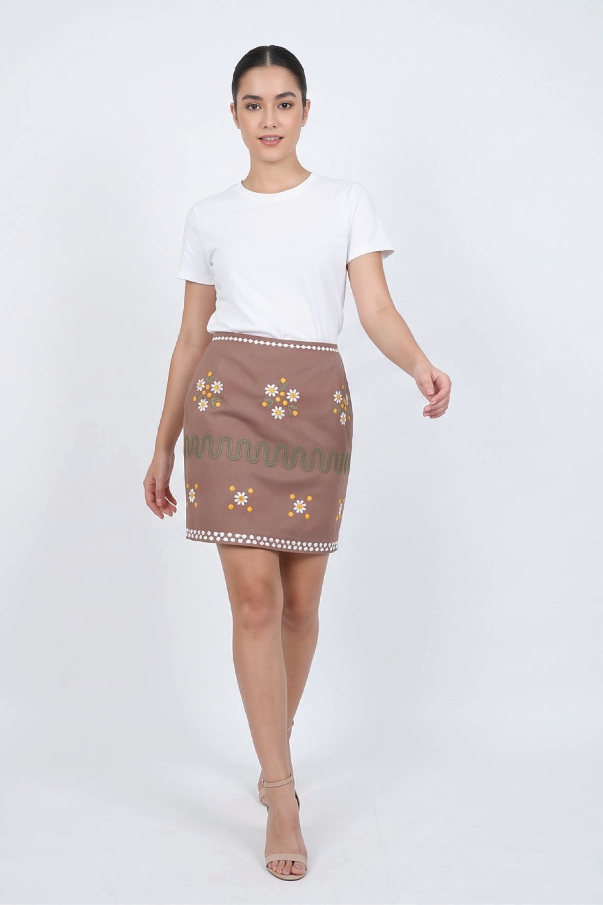 Fanm Mon Roya Skirt on model featuring daisy embroidery, decorative embroidered bands and a high-waisted mini silhouette