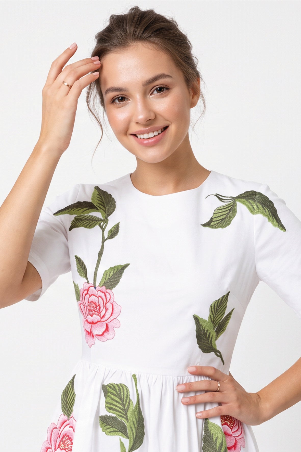 Close-up of Fanm Mon Rumen Dress in white highlighting the round neckline, short sleeves, pink rose embroidery with red detailing, and intricate green botanical foliage across the fitted bodice.