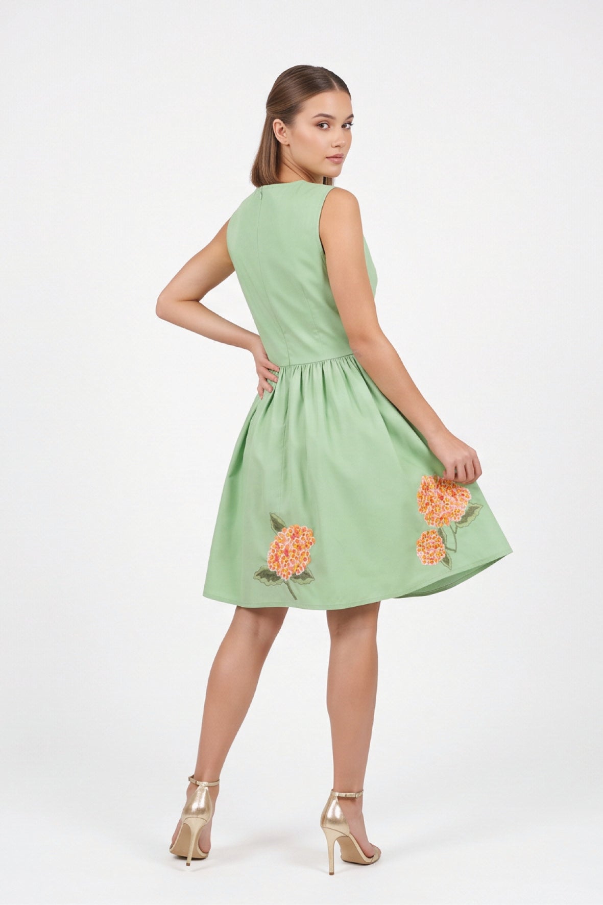 Back view of the Fanm Mon Seher Dress with a fitted sleeveless bodice, gathered skirt and floral embroidery along the hem