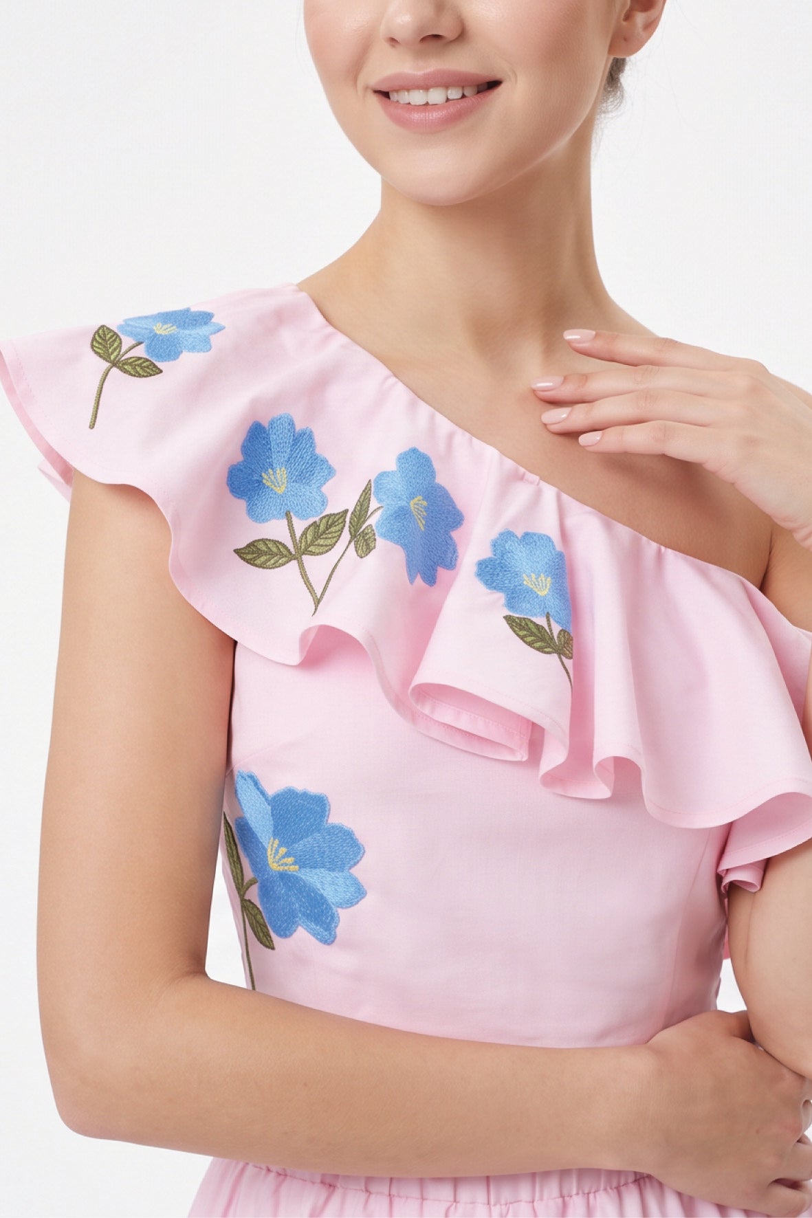 Close-up of the Fanm Mon Tamira Set highlighting the one-shoulder ruffled neckline and delicate blue floral embroidery with yellow centers and green leaves