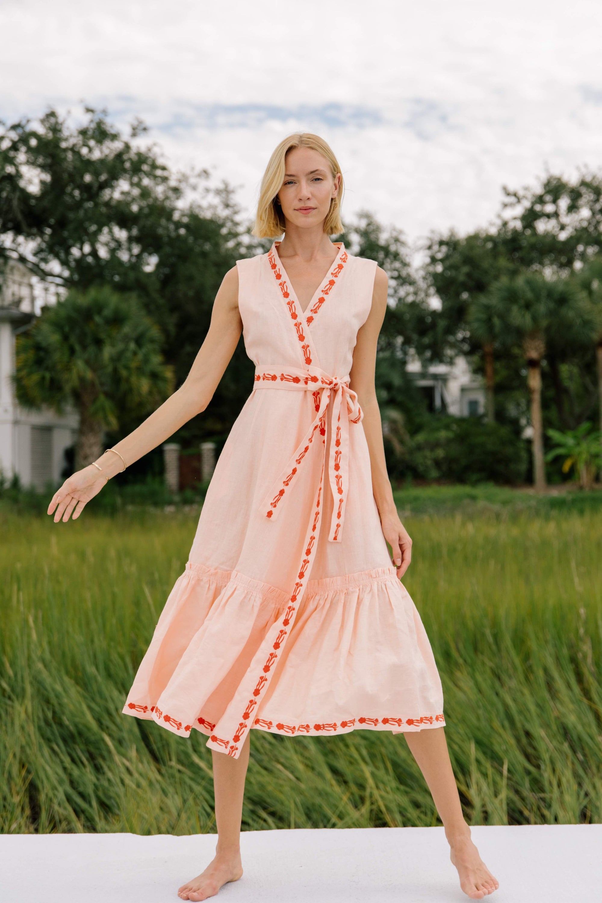 Ceylin Midi Linen dress. This 100% linen sleeveless dress features contrast in its tonal floral embroidered detail, along the trim and waist belt, to create a striking look.
