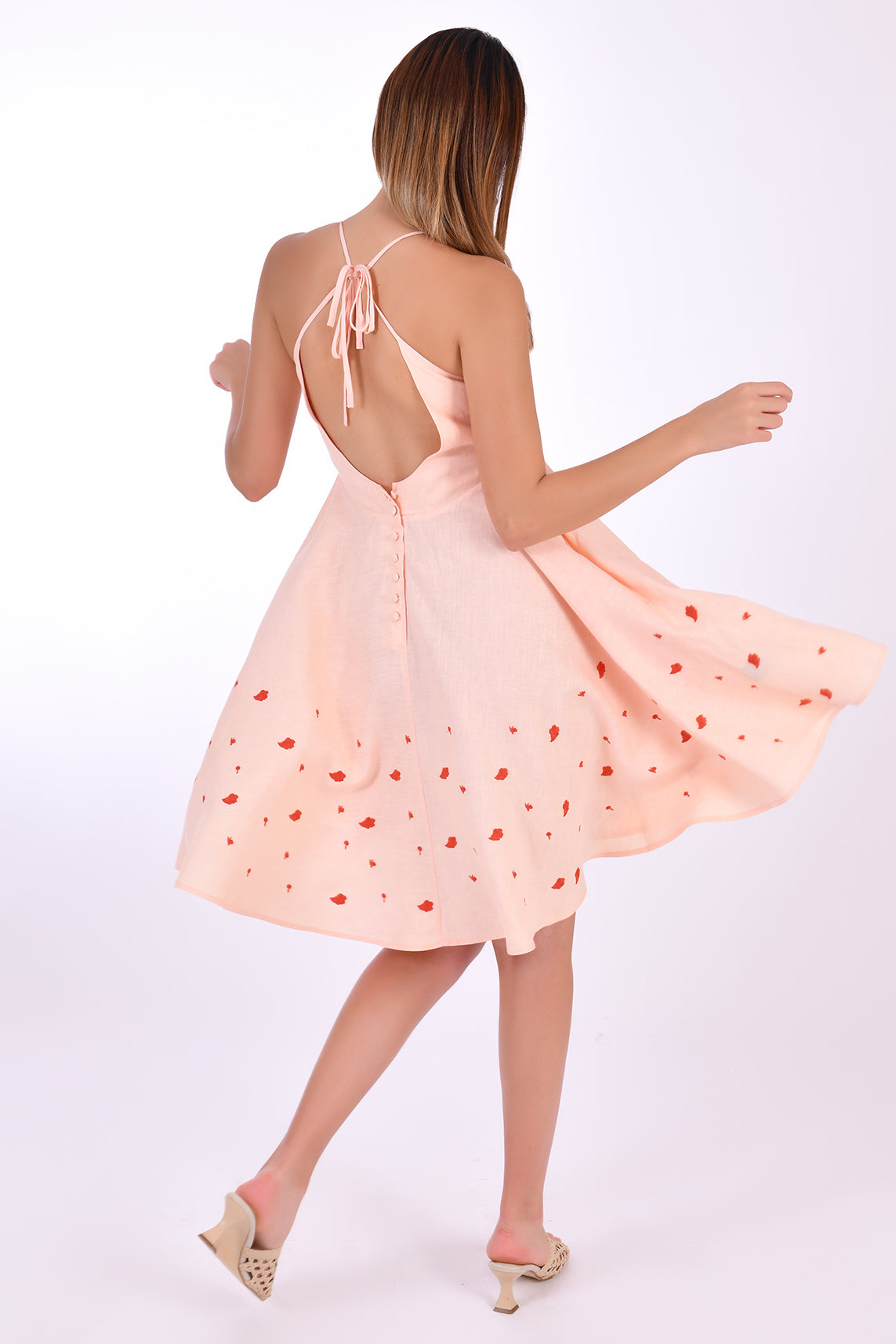 Fanm Mon Mella Dress, Back View. Showcases back tie and zipper closure, embroidery detail and movement of the fabric.  
