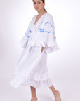 Fanm Mon Hati Linen Dress, Showcasing the movement of the Linen fabric, bell sleeves and ruffled hem. Side View.