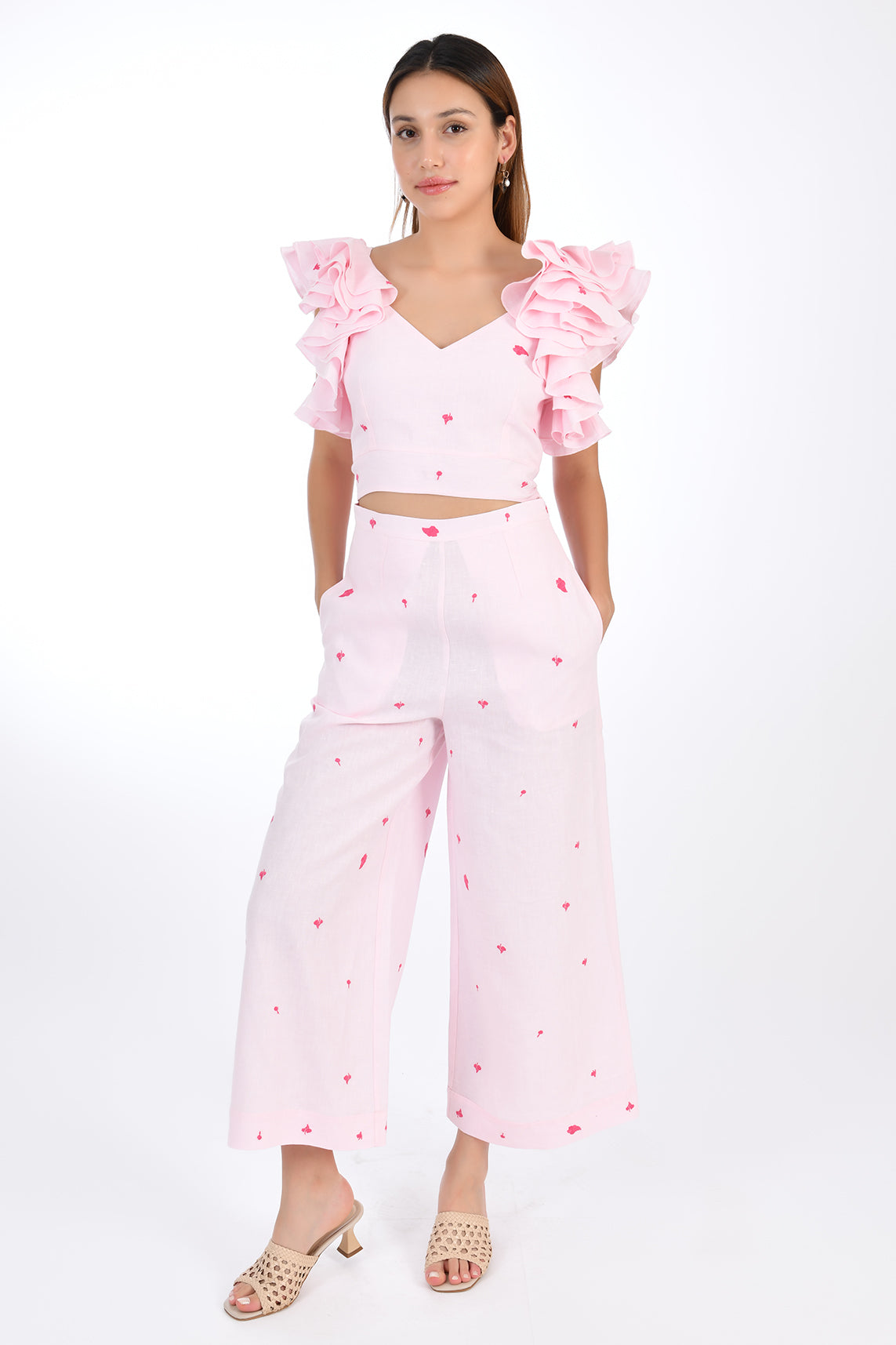 FANM MON ANAIS 2 Piece Linen Top and Pants Set. Sleeveless top features ruffles with intricate embroidery detail and back detail of bow and button closure, while the wide-leg pants boast a matching embroidery detail and on-seam pockets for a cohesive look. Front View.