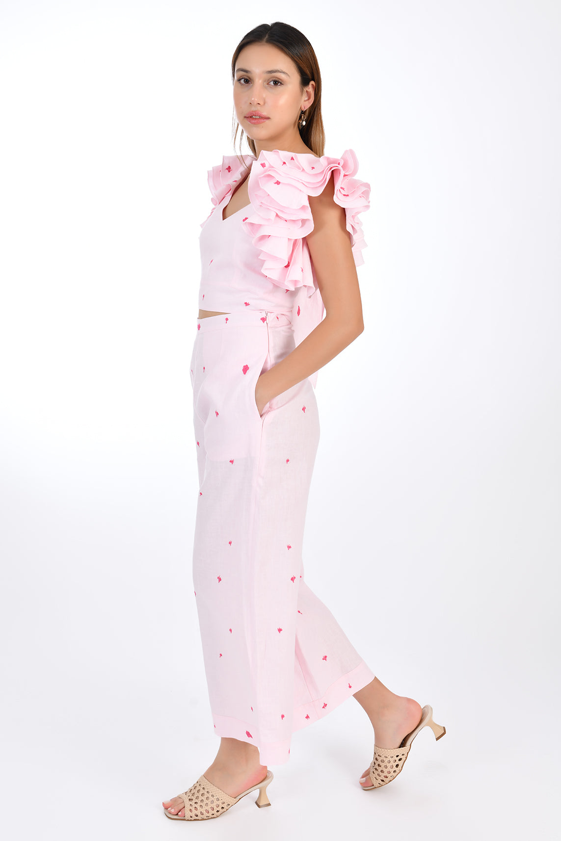 FANM MON ANAIS 2 Piece Linen Top and Pants Set. Side View, showcasing sleeveless top ruffles with intricate embroidery detail and on-seam pockets featured on wide-leg pants that boast a matching embroidery detail for a cohesive look. 
