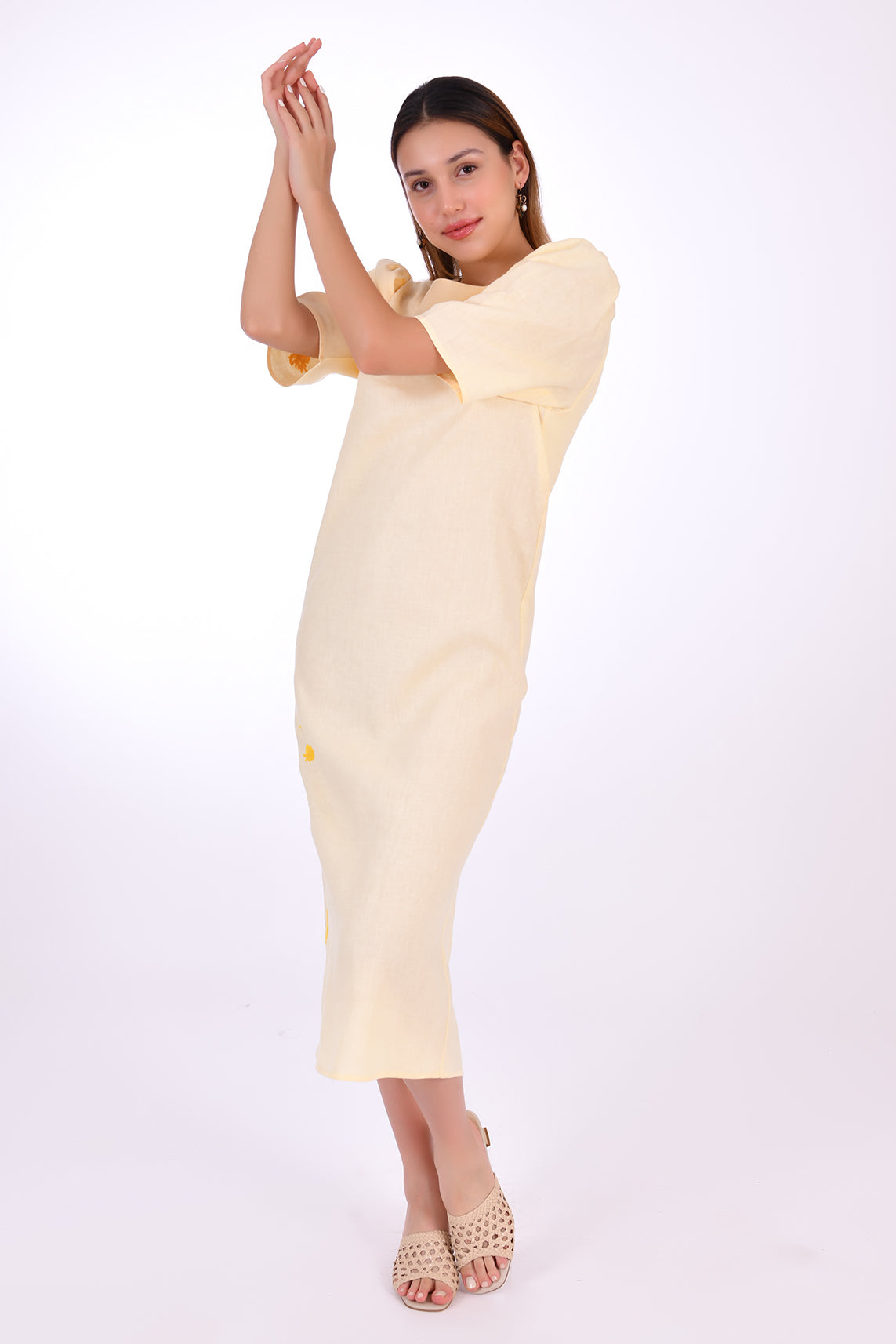 Fanm Mon Doga Midi Linen Dress, Side View (not belted). Short Sleeve 100% Linen Dress, featuring a peephole open back and button closure. Round neck, with a belt for the waist (can be worn with or without), and features front embroidery detail.