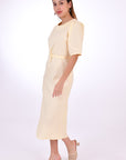 Fanm Mon Doga Midi Linen Dress, Side View Belted. Short Sleeve 100% Linen Dress, featuring a peephole open back and button closure. Round neck, with a belt for the waist (can be worn with or without), and features front embroidery detail.