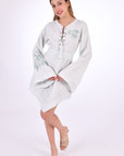Fanm Mon Boze Linen Dress Front View. Kaftan Style Linen Dress with wide kimono embroidered sleeves and handkerchief hem and tie front.  Easy slip-on wear,  mini length loose fit dress. 